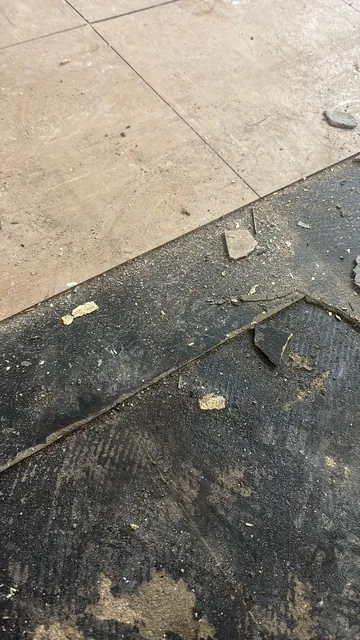 Black bitumen mastic floor removal in a WC1 flat
